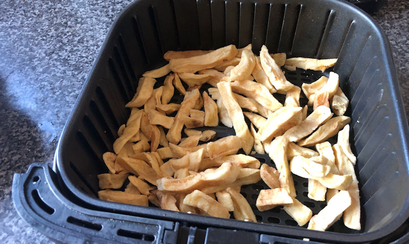 Separated, cold chip shop chips sitting in air fryer basket