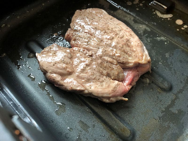 Lamb leg steak cooked in bottom of air fryer basket