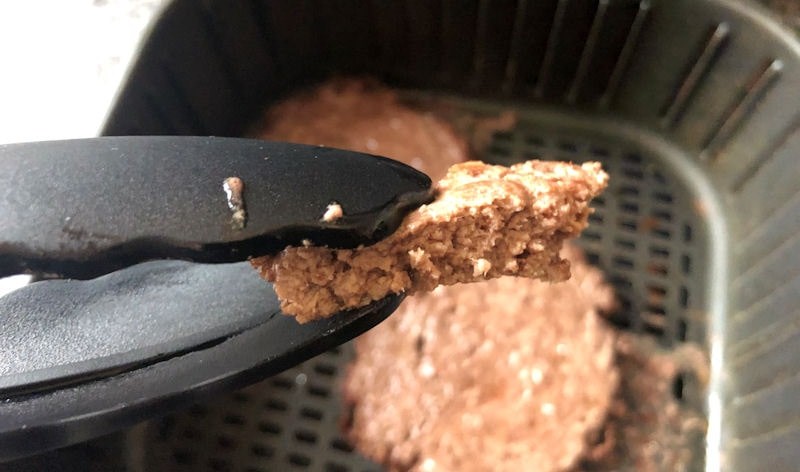 Close shot of cut open beef patty displaying inside texture