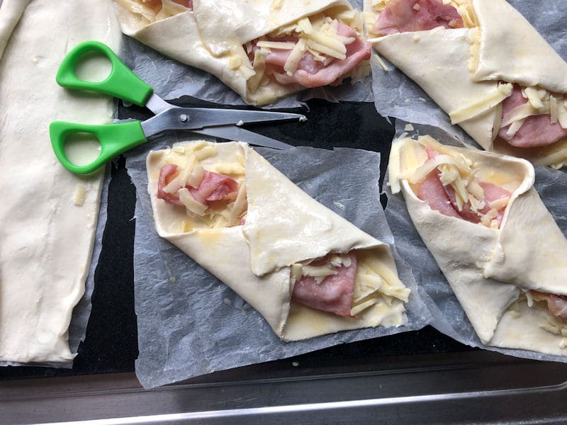 Scissors used to cut around puff pastry parchment paper base