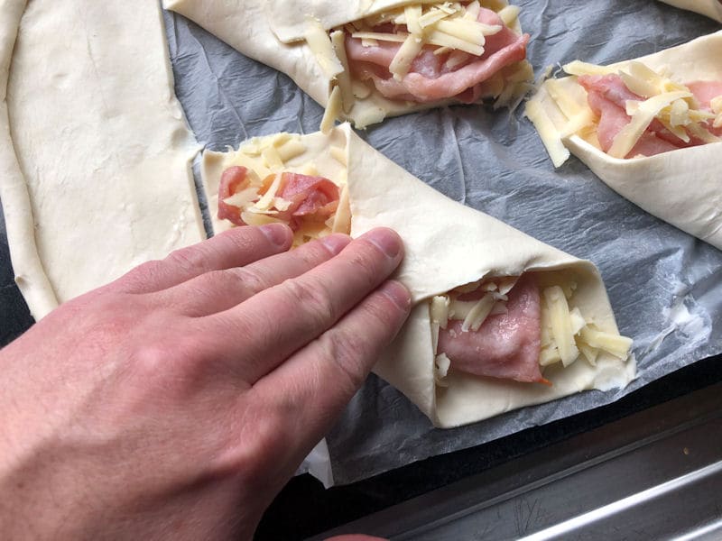 My hand firmly pressed on bacon turnover pastry