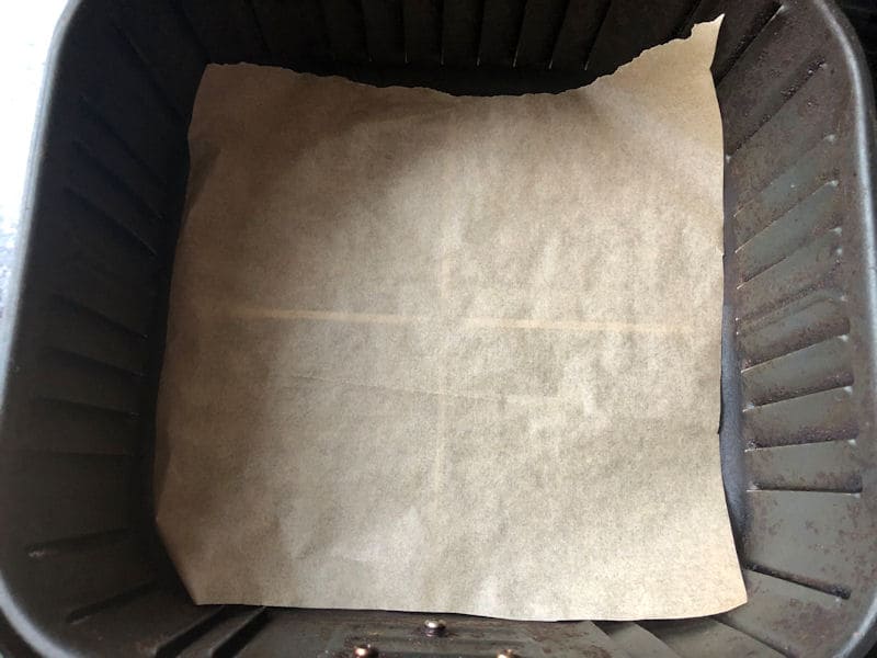 Cut to size parchment paper in bottom of air fryer basket