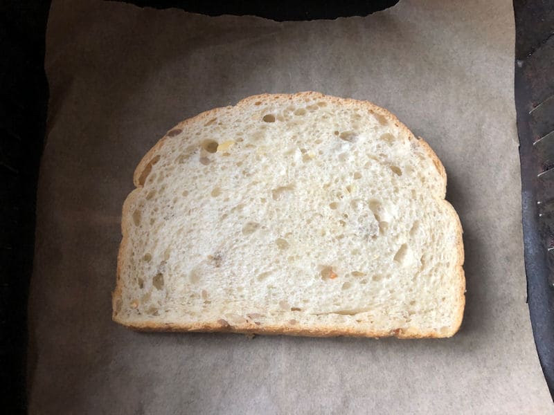 White bread slice positioned on parchment paper lining