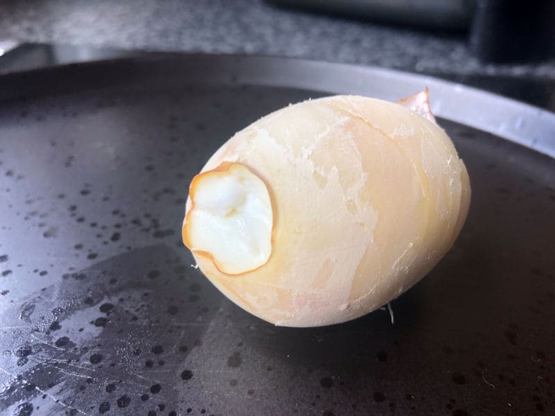 Baked in appearance air fried egg with a brown rough texture