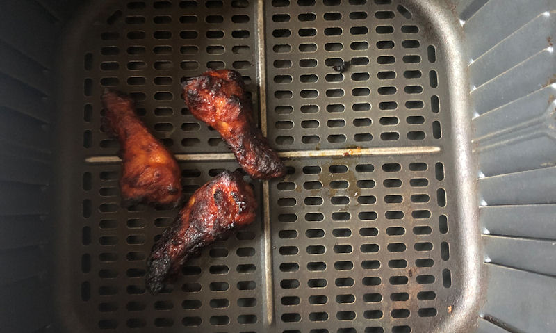 Korean spicy chicken wings sitting in big air fryer basket