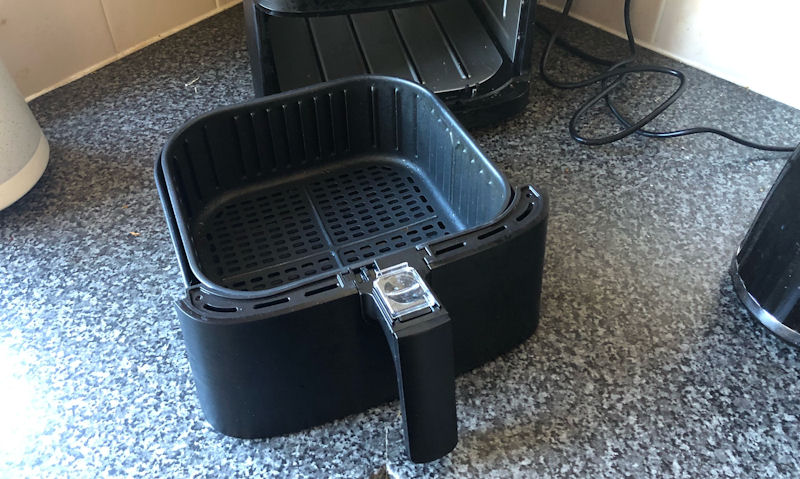 My Cosori CP158-AF air fryer basket sat on countertop