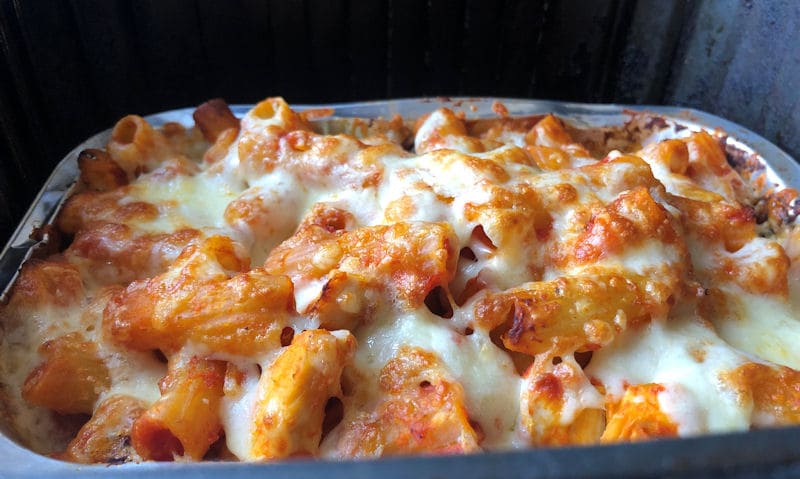 Air fried pasta bake with melted cheese in foil tray