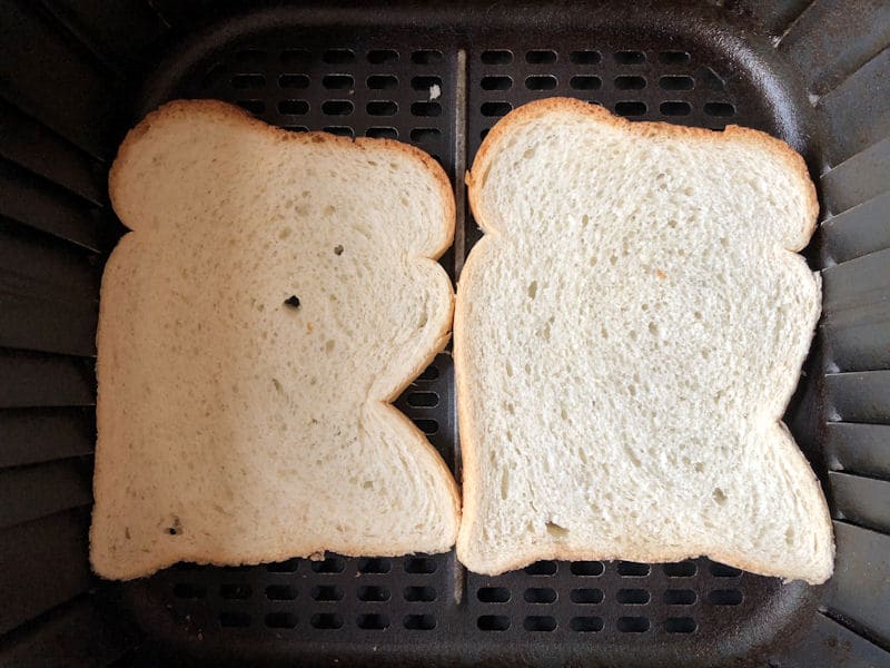 Bread positioned on bottom of air fryer basket