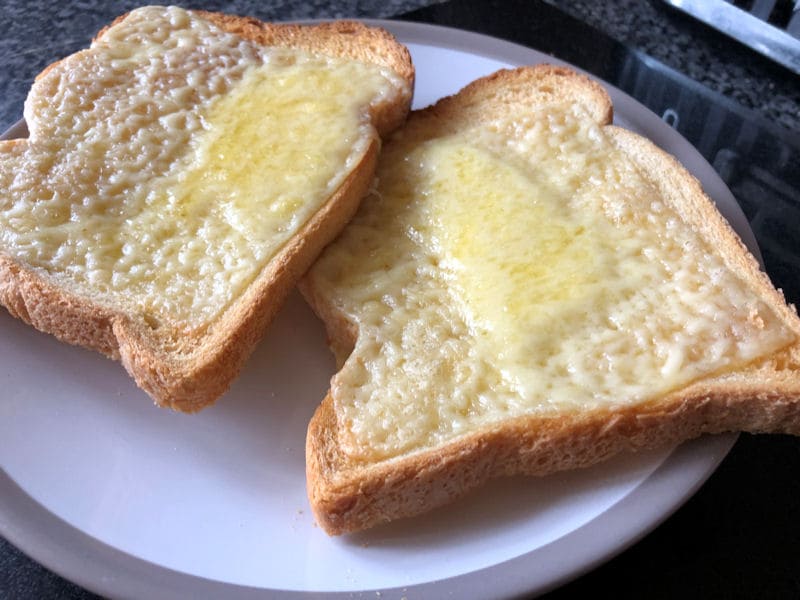 Air 
fried cheese on toast sitting on small plate ready to be eaten