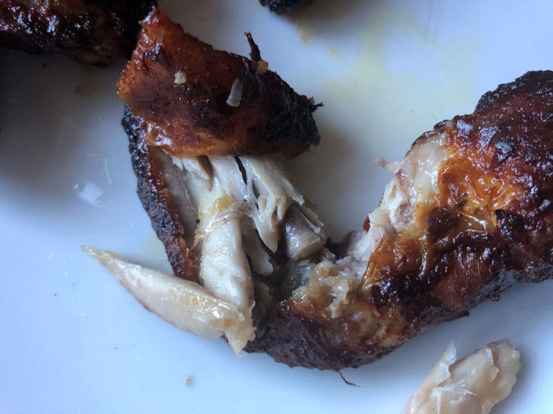 Air fried chicken wing split open to reveal a juicy meat