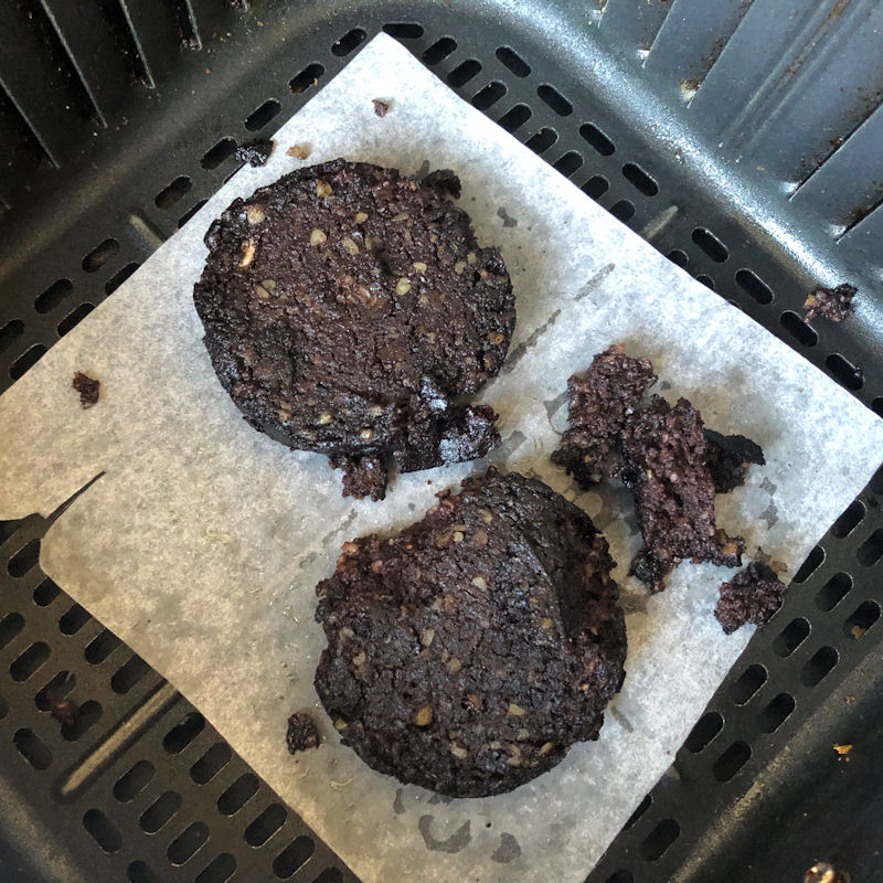 Black pudding slices in air fryer, on parchment paper