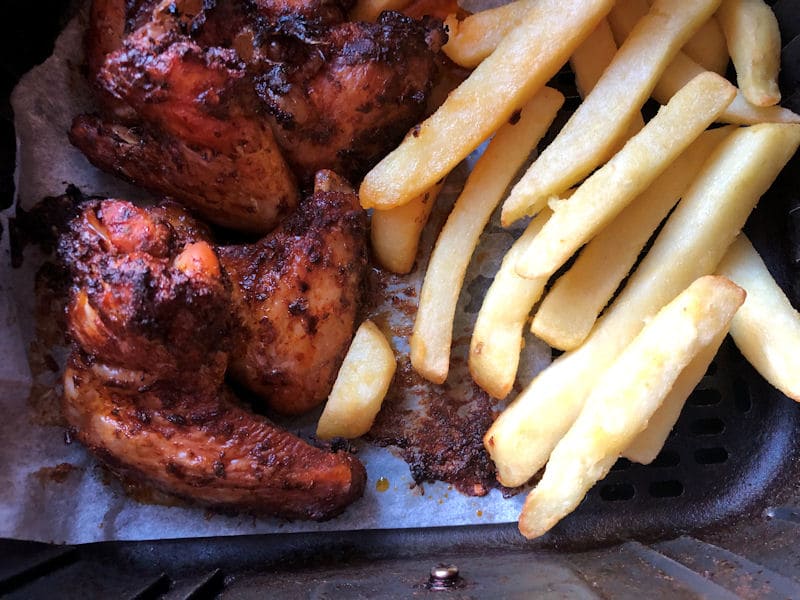 BBQ chicken drumsticks along with chips in air fryer