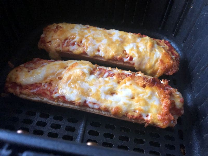 Air fried cheese and tomato pizza bread in air fryer basket