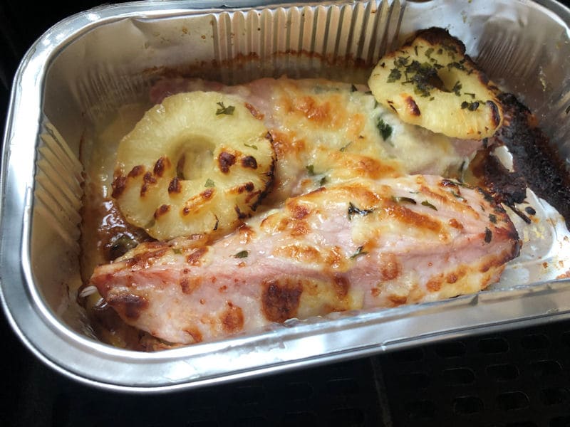 Store-bought gammon steaks with pineapple, cheese ready meal in 
  foil tray