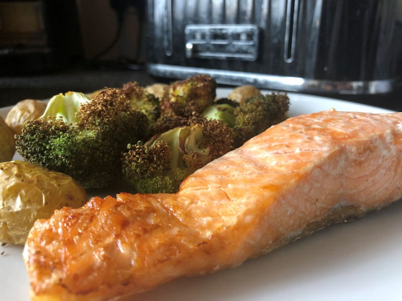 Salmon and vegetable dinner with visibly brown broccoli florets