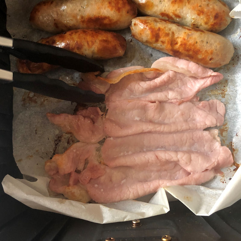 About to turn over a bacon rasher with the air fryer basket open