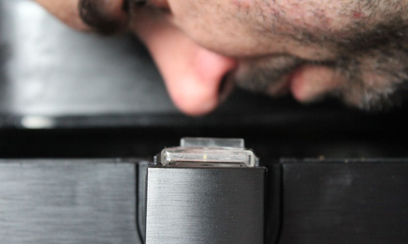 I am leaning over sniffing inside air fryer basket in profile shot