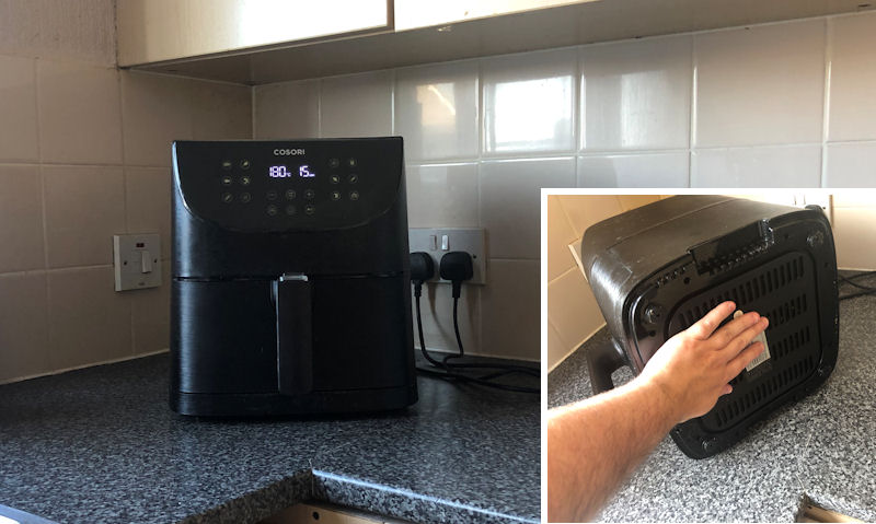 Cosori air fryer sitting on counter; me touching bottom of air fryer