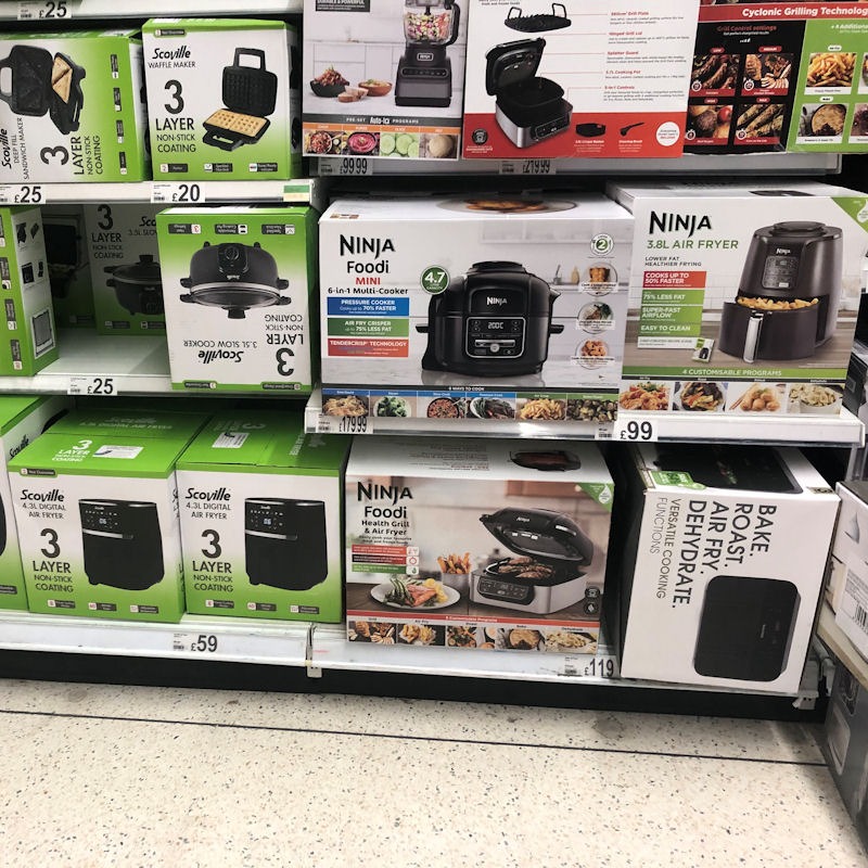 Selection of Asda air fryers displayed on low to ground shelves