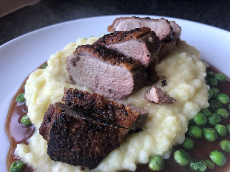 Duck breast served with mash potatoes, pies and gravy