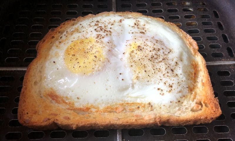 Single slice of double egg on toast positioned in air fryer