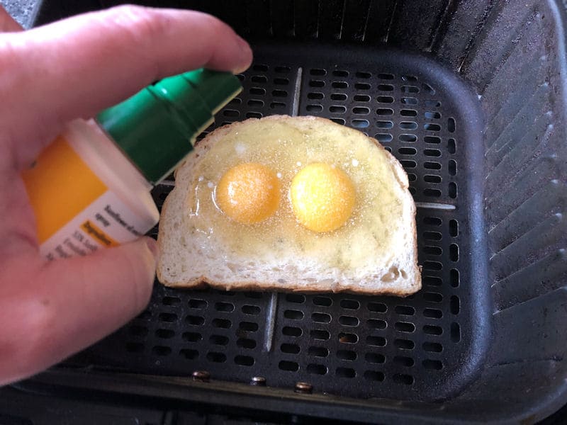 Spraying eggs with Sunflower oil, set in bread imprint