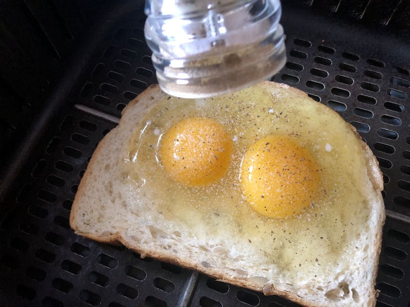 Grinding freshly ground pepper on raw eggs