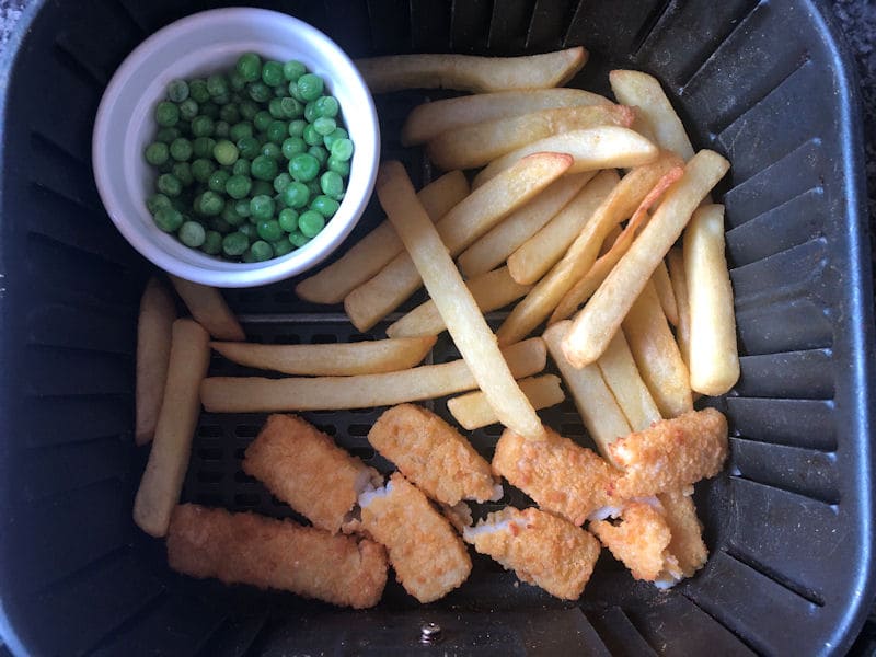 Chips, frozen peas in ramekin and chips in air fryer basket