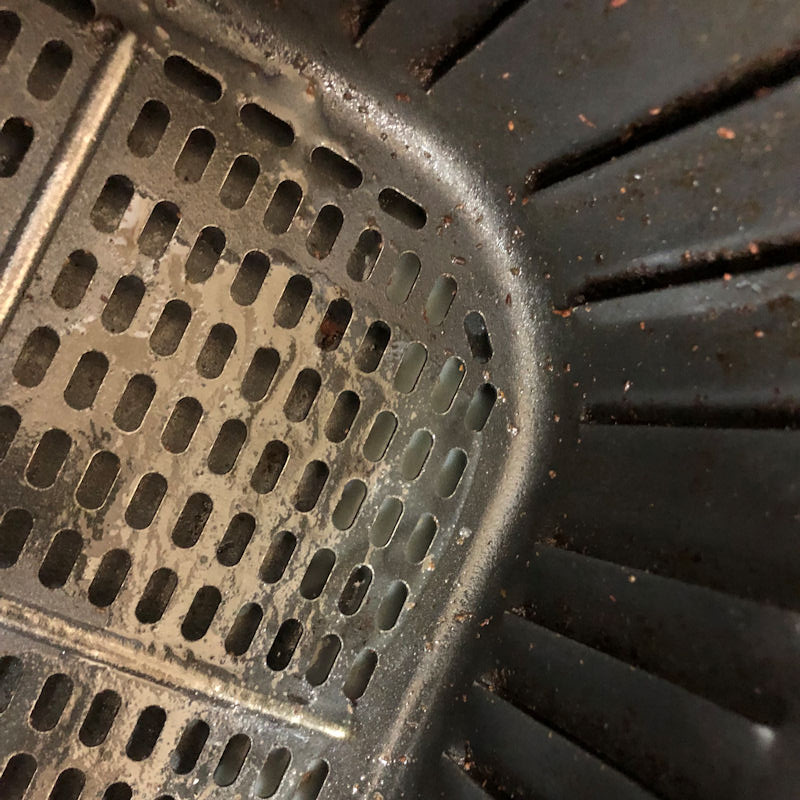 Grease, crumbs spilled in to basket and container