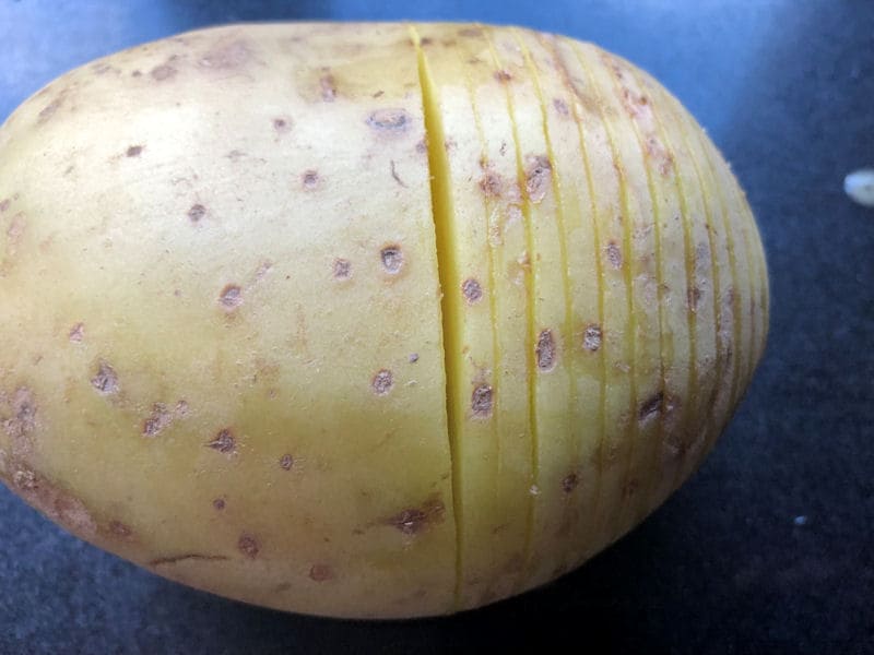 Close up look of finely sliced Hasselback potato