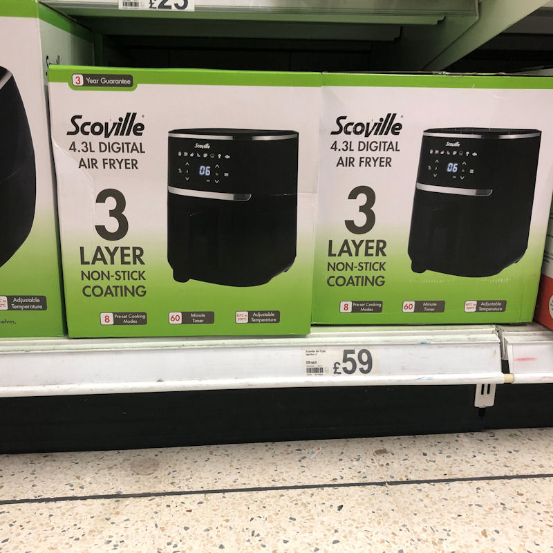 Close look at Scoville air fryers on low shelf, with prices clearly marked