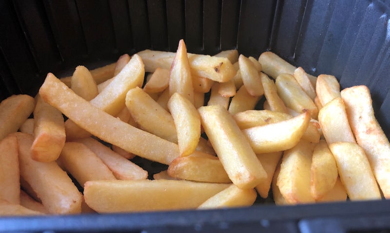 Freshly cooked fries filled high in Cosori air fryer basket