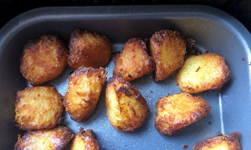 Air fried roast potatoes inside oiled baking tray