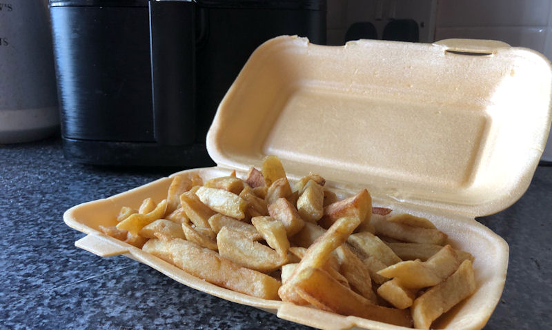 Portion of chippy chips in polystyrene box, sitting on countertop