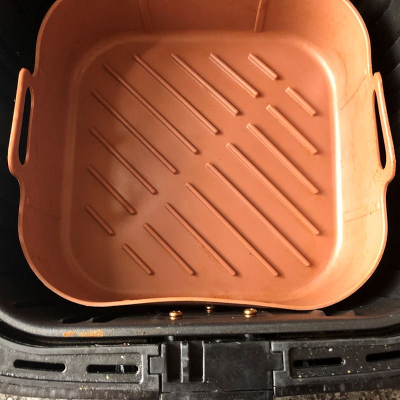 Empty silicone basket in Cosori air fryer basket