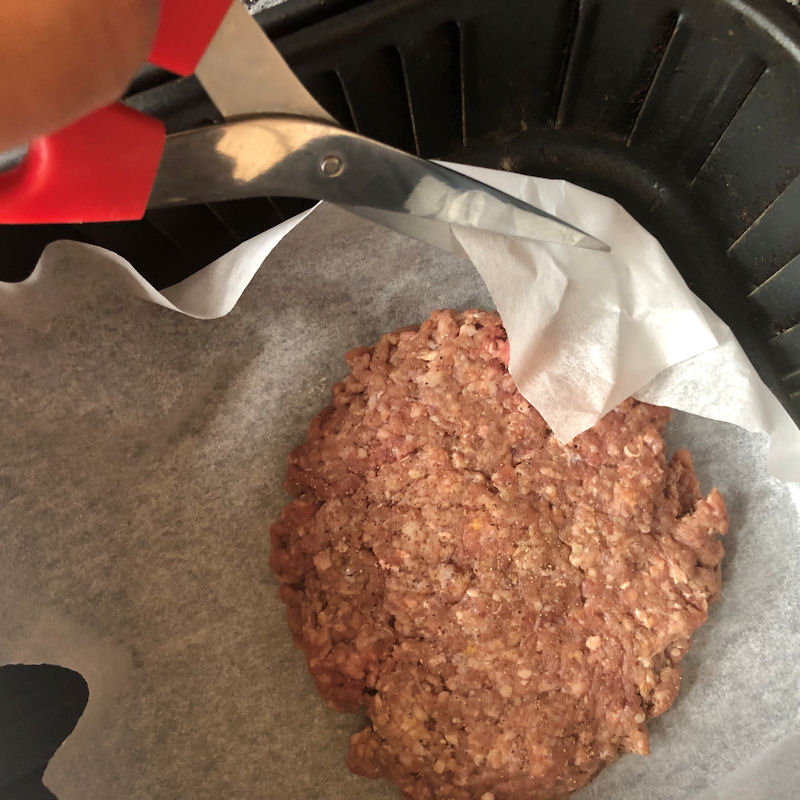 Me cutting  parchment paper corners off to prevent burning