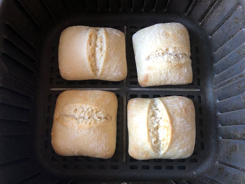 Four ready to bake rolls in formation in air fryer basket