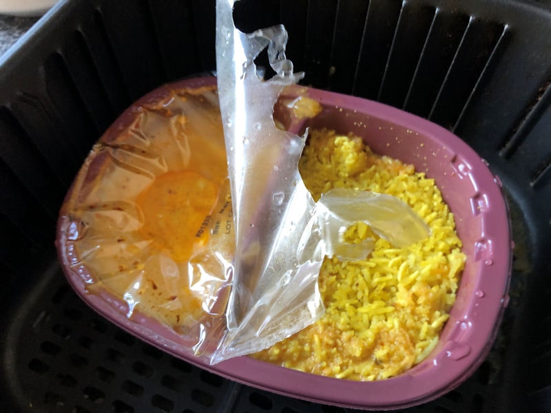 Chicken Korma plastic film lid melted on heating element