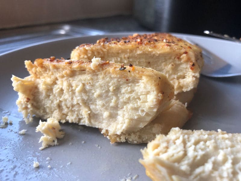 Reheated chicken breast served on plate, cut in slices