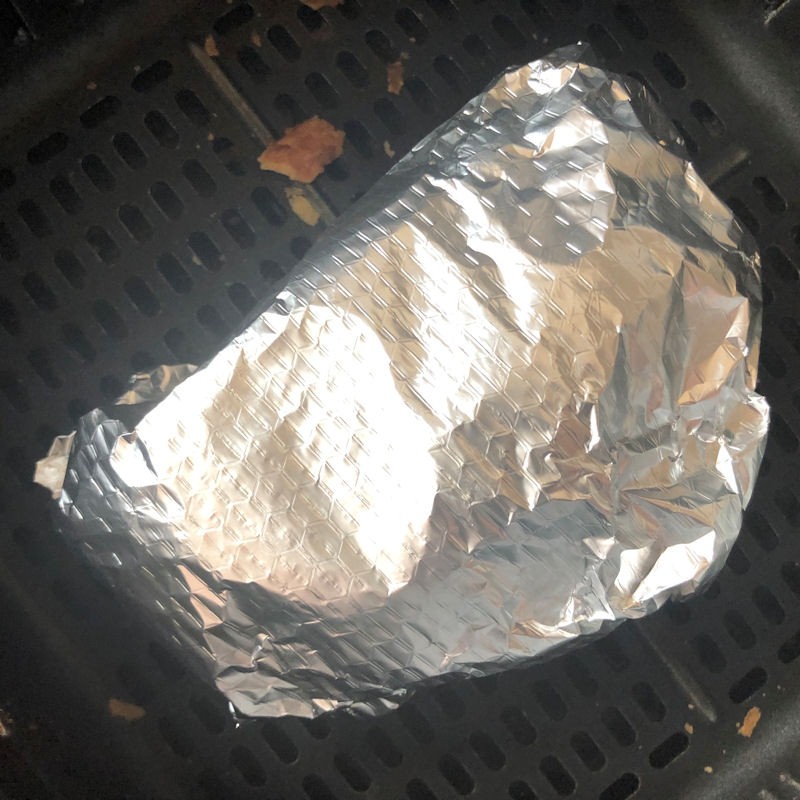 Single pasty wrapped up in loose foil parcel