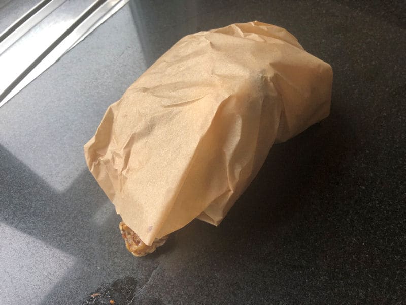 Bundle of eight chicken wings wrapped in parchment paper