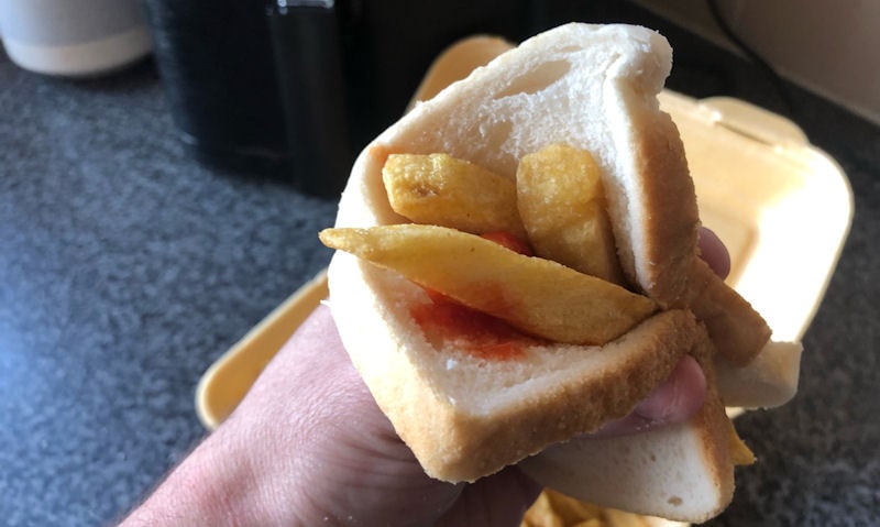 Me holding an homemade chip butty with tomato ketchup