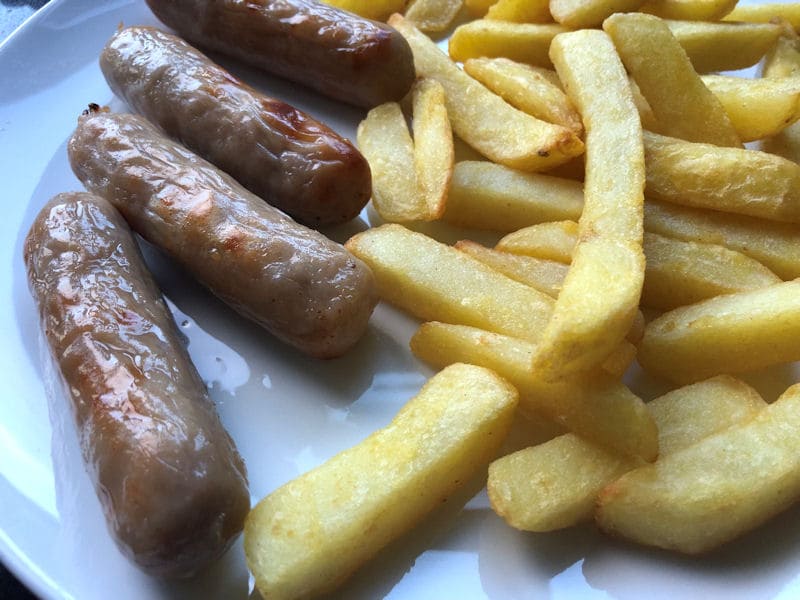 Plated portion of air fried chips with sausages