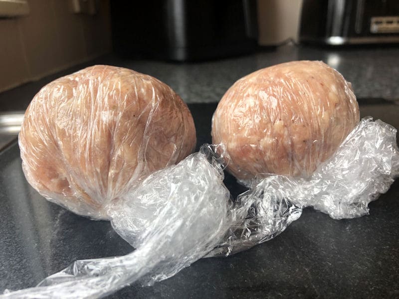 Raw Scotch Egg balls wrapped in clingfilm