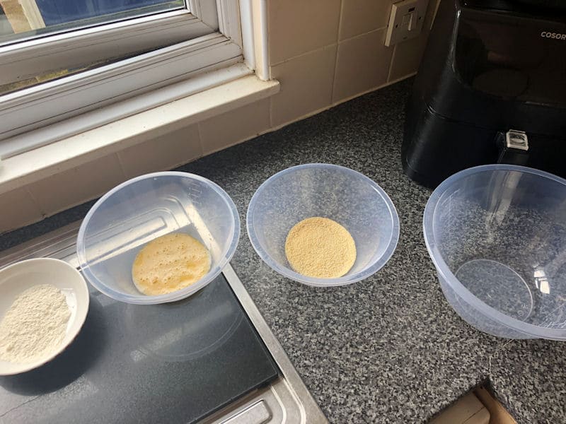 Line up of four dredging bowls on kitchen counter