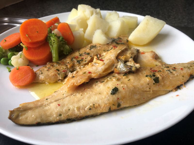 Plated 
  Sea Bass fillets with potatoes and mixed vegetables