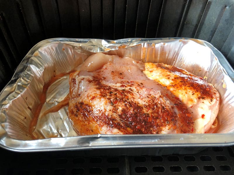 Peri Peri seasoning applied to chicken breast in foil tray