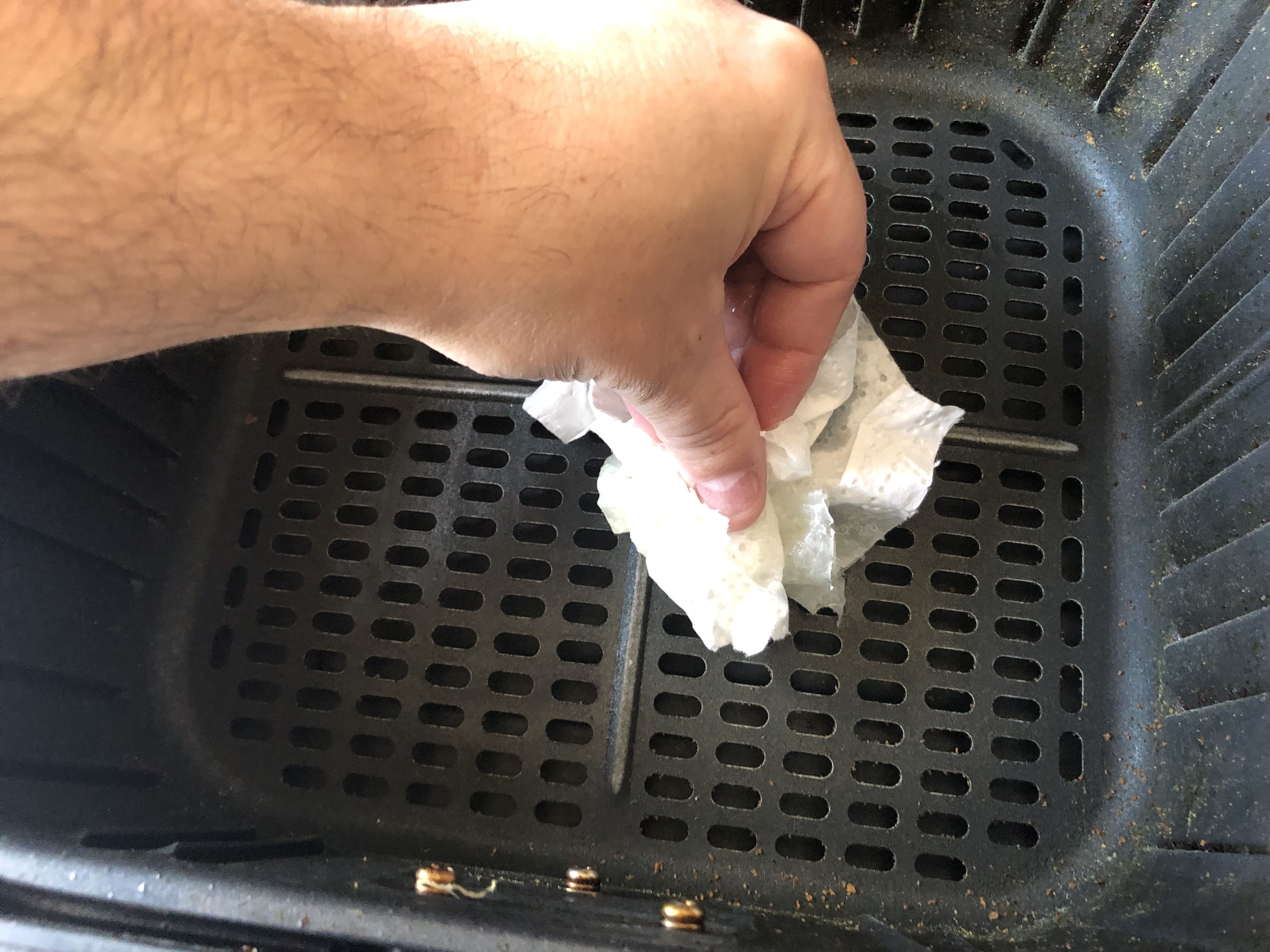 Rubbing oil soaked paper towel on bottom of air fryer basket