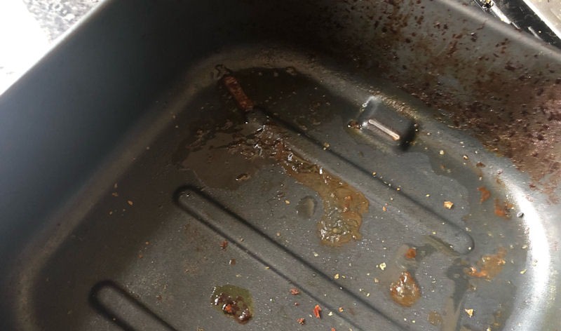 Shot of greasy, disgusting outer air fryer basket container